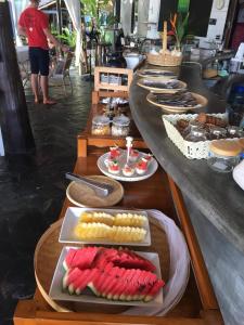 a long table with plates of food on it at Cookies Salad Resort in Salad Beach