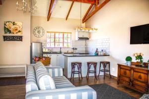 a living room with a couch and a kitchen at Modern Farm in Lichtenburg