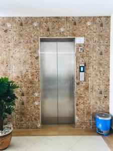 a metal elevator in a building with a stone wall at Langkawi De Bleu Hotel in Kuah