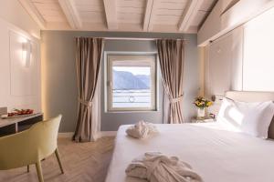 a bedroom with a large bed and a window at Araba Fenice Hotel in Iseo +146 photos