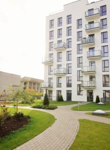 a white building with a walkway in front of it at Elzbietos centro apartamentai in Vilnius