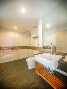 a bathroom with a sink and a toilet and a shower at I Dee Hotel Patong in Patong Beach