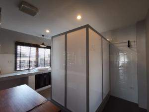 a bathroom with a glass shower and a sink at The Besavana Phuket - SHA Extra Plus in Phuket Town