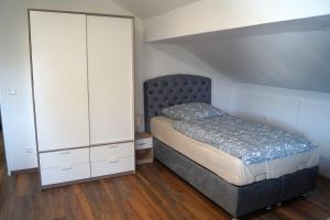 a bedroom with a bed and a white cabinet at OasenEck in Limburg an der Lahn