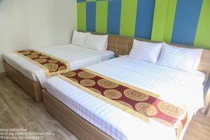 dos camas sentadas una al lado de la otra en una habitación en Hùng Vương Hotel Hạ Long en Ha Long