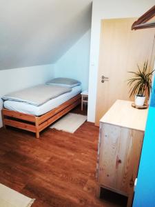 a room with a bed and a wooden floor at Apartmány Réví in Hlohovec