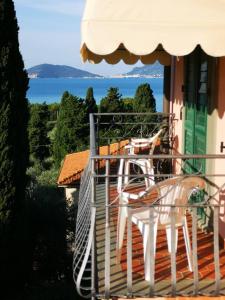 a balcony with a table and chairs on a house at Locanda Miranda in Tellaro
