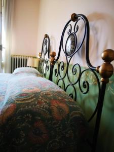 a bedroom with a bed with a floral bedspread at Locanda Miranda in Tellaro