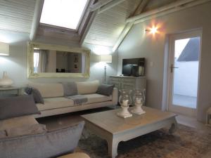 a living room with a couch and a table at Oppidraai B in Paternoster