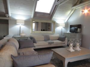 a living room with a couch and a table at Oppidraai B in Paternoster +3 photos