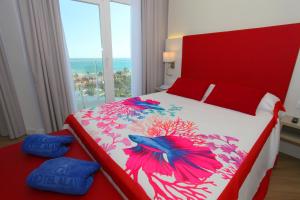 a bedroom with a large bed with a red headboard at Hotel Alay - Adults Only Recommended in Benalmádena