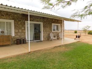 a screened in porch of a house at Meteorite Rest Camp in Groutfontein