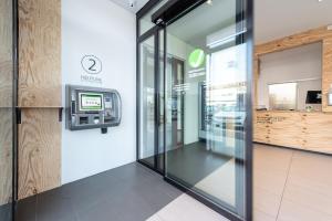 an entrance to a supermarket with a cash machine at a2 HOTELS Denkendorf - Airport & Messe in Denkendorf