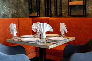 a table with plates and napkins on top at Labirint Boutique Hotel in Bucharest
