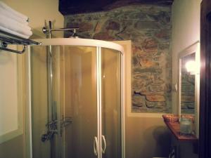 a shower in a bathroom with a stone wall at Hostal De Montaña La Aldeya in Villablino +9 photos