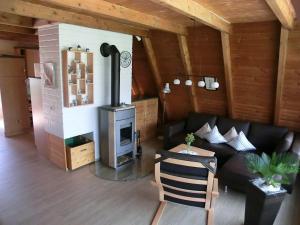 a living room with a couch and a stove at Ferienhaus Hubertus, 95059 in Rhauderfehn