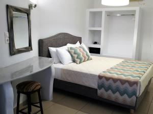 Uma cama ou camas num quarto em Hotel Mylos
