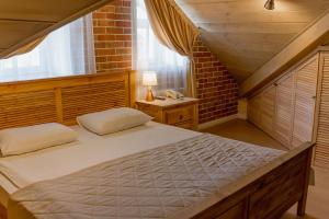 a bedroom with a bed and a brick wall at Kremlyovskiy Park in Ryazan