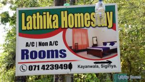 a sign for a house with a bottle of water on it at Lathika Homes in Sigiriya