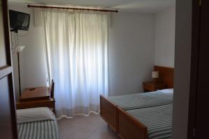 Postel nebo postele na pokoji v ubytování Albergo Miravalle