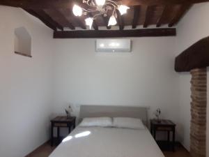 a bedroom with a bed and two night stands at Torre alle Antiche Mura in Montepulciano