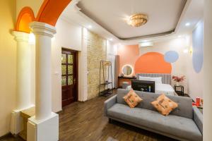 a living room with a couch and a bed at Ohana House in Hanoi