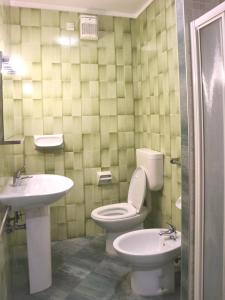 a bathroom with a toilet and a sink at Michelangelo Beach in Lignano Sabbiadoro