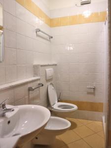 a bathroom with a toilet and a sink at Michelangelo Beach in Lignano Sabbiadoro