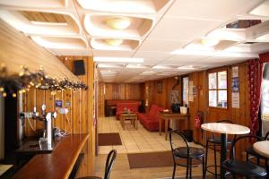 a restaurant with chairs and tables in a room at Hotel Le Cairn in Les Deux Alpes