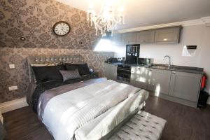 a bedroom with a bed and a clock on the wall at No 10 The Abbey in Norwich