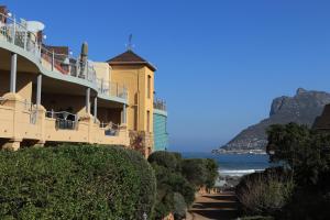a building on a hill next to the ocean at 29 The Village in Hout Bay