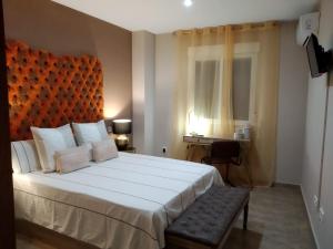 a bedroom with a large bed and a desk at Duplex Jalama II in Moraleja