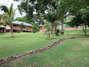 un patio con una casa en el fondo con árboles en Cocoa Village Guesthouse, en Obo