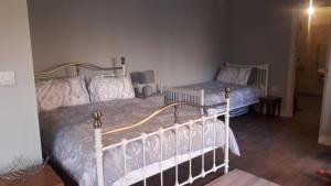 a bedroom with two beds and a night stand at The Croft in Sedgefield