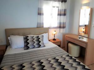 Uma cama ou camas num quarto em Hotel Mylos