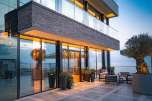 a building with glass doors and a patio at Hotel Polet Chayki in Sochi