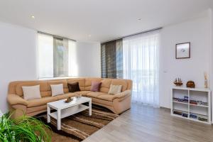 a living room with a couch and a table at Villa Oasis Cypress in Čilipi