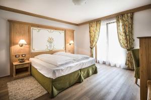 Ένα ή περισσότερα κρεβάτια σε δωμάτιο στο Hotel Cristallo