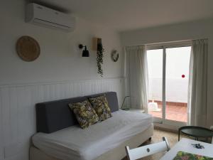 a living room with a couch and a window at Apartamentos Villa Nadine in Playa de Palma