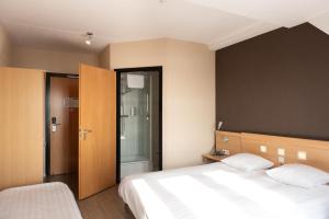 Postel nebo postele na pokoji v ubytování Hotel Hoogeerd by Flow Niftrik - Nijmegen