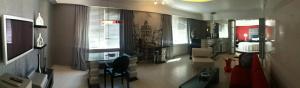 a living room with two windows and a couch at Surmeli Istanbul Hotel in Istanbul