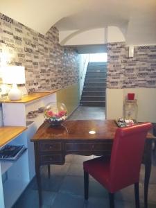 a dining room with a wooden table and a red chair at Hotel Malta in Milan