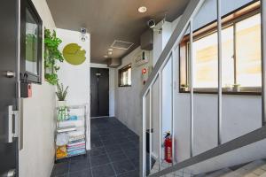 an office hallway with an apple logo on the wall at Akabane TK Building 102 in Tokyo +41 photos