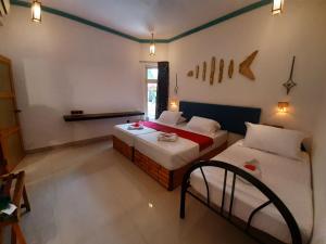 Gulta vai gultas numurā naktsmītnē Dream Inn Sun Beach Hotel Maldives