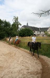 een groep mensen die paardrijden over een onverharde weg bij Pferd - Spaß - Entspannung in Staitz