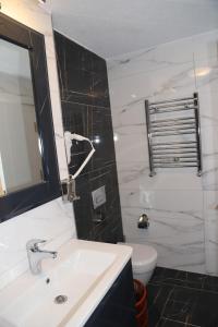 a bathroom with a sink and a toilet at Grand Kavi Hotel in Istanbul