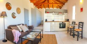 a living room with a couch and a table at BanSala Villas in Vounaria