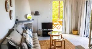 a living room with a couch and a table at BanSala Villas in Vounaria