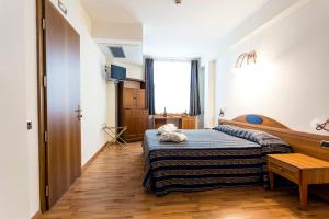 Postel nebo postele na pokoji v ubytování Hotel Porta Del Sole