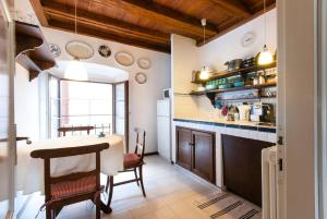 a kitchen with a table and a dining room at Miralago Apartments Villa Trotti in Bellagio